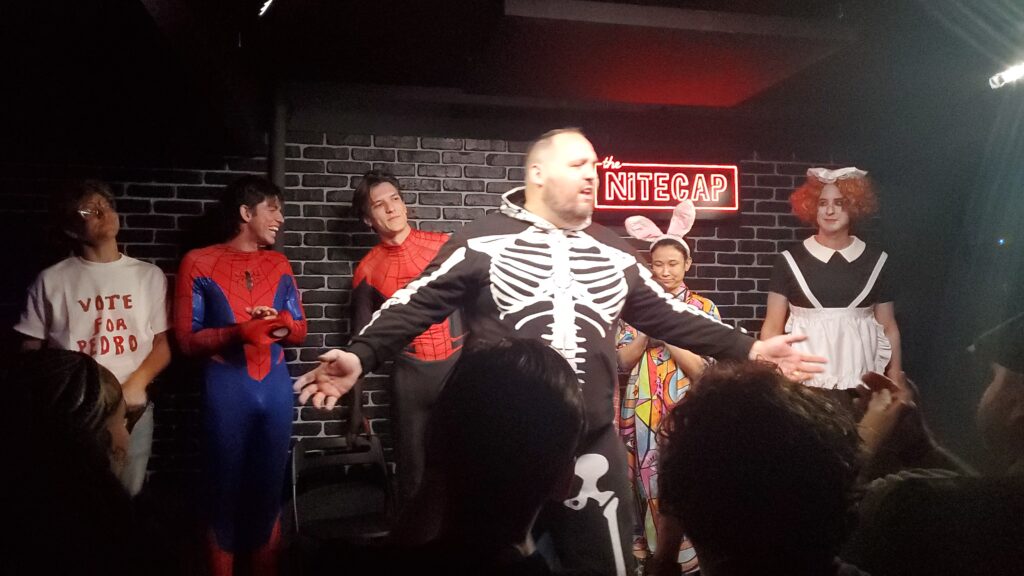 the improv company's director and producer in front of the actors