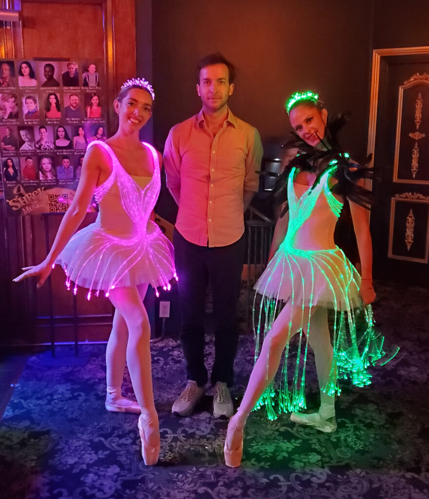 the ballerinas who played aurora and carabosse standing on either side of me, ethan hulbert, in the lobby after the ballet