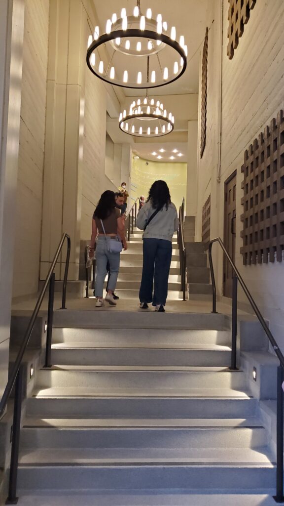 ford theater inner hallway with steps, stone walls, chandeliers