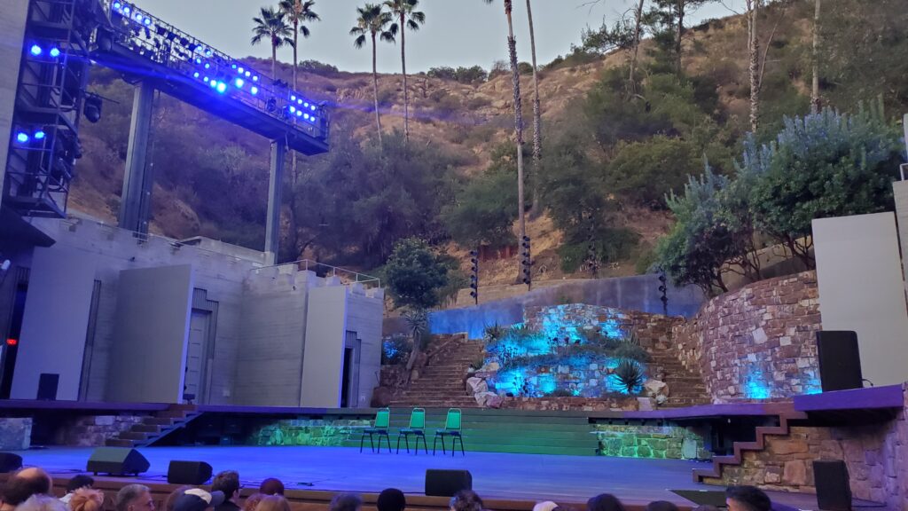 ford theater los angeles stage in daylight evening from my seat in audience, palm trees and hill behind
