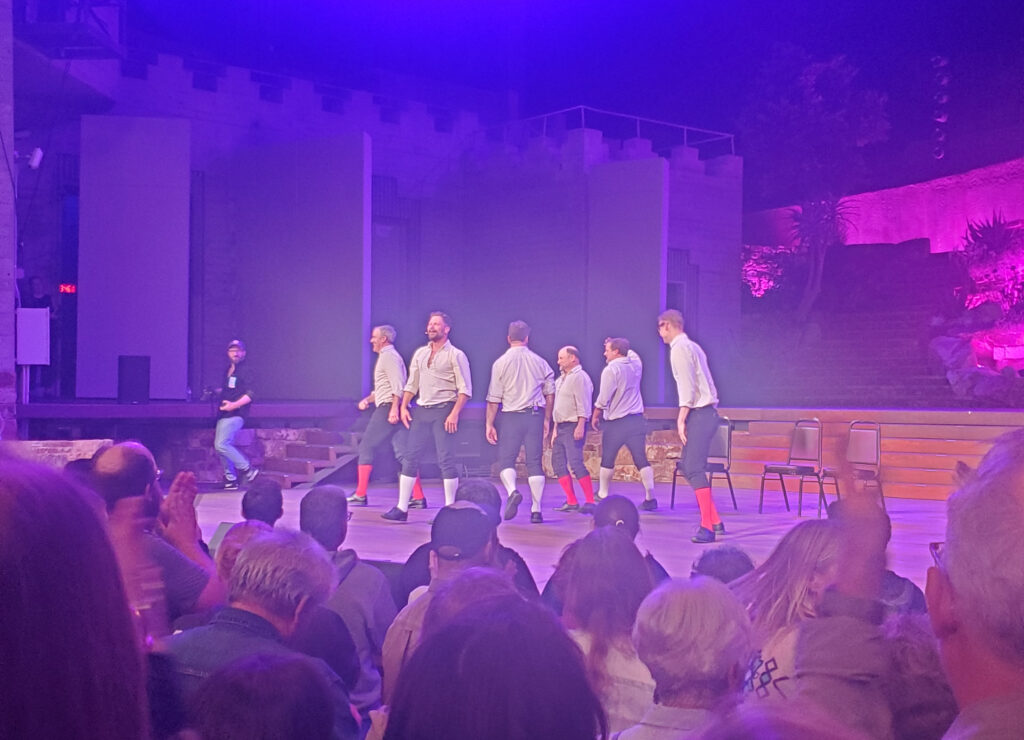 a hazy photo of the improv shakespeare troupe leaving the ford theater stage