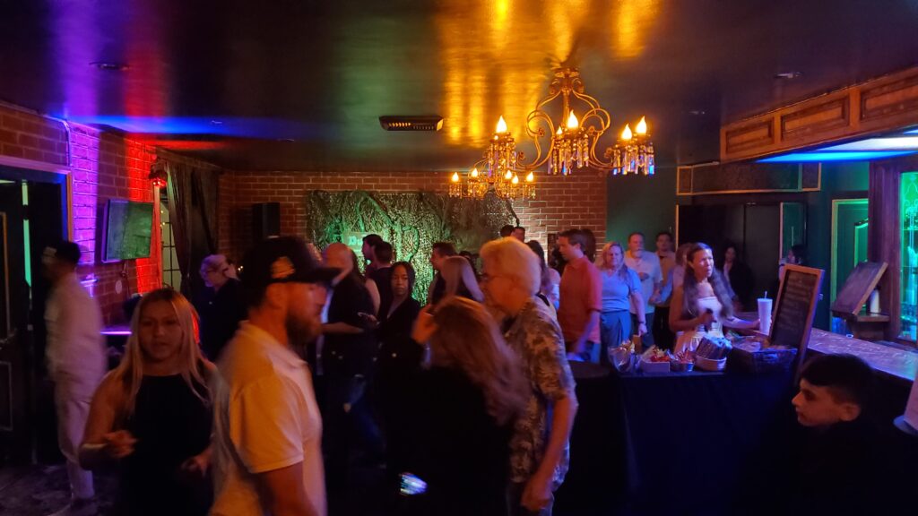 the lobby and bar and crowd inside the entrance room to the nocturne theater in glendale, ca