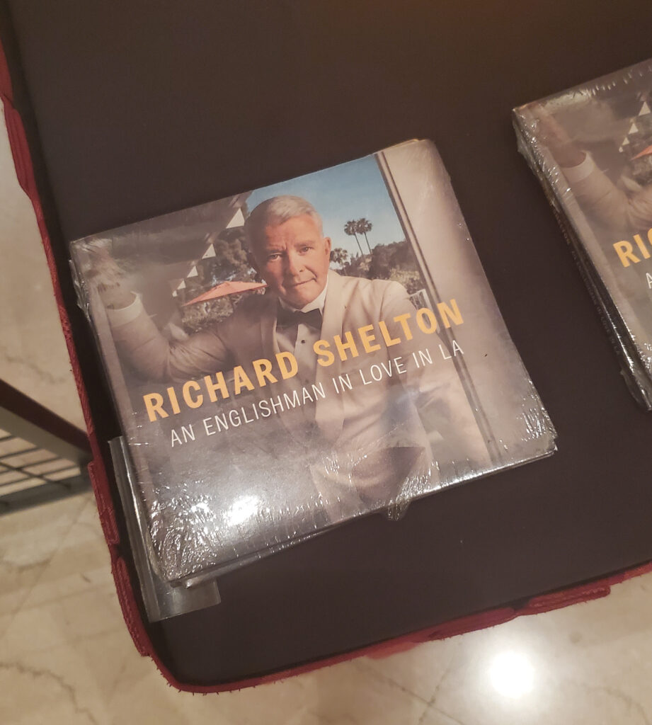 a music cd in a case in plastic on the merch table, an englishman in love in la album