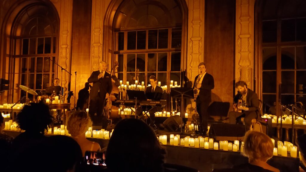 sextet (including richard shelton) or shelton plus his quintet of pure soul jazz instrumentalists - drummer, bass player, keyboardist, sax player, guitarist, on candlelight stage playing nat king cole cover