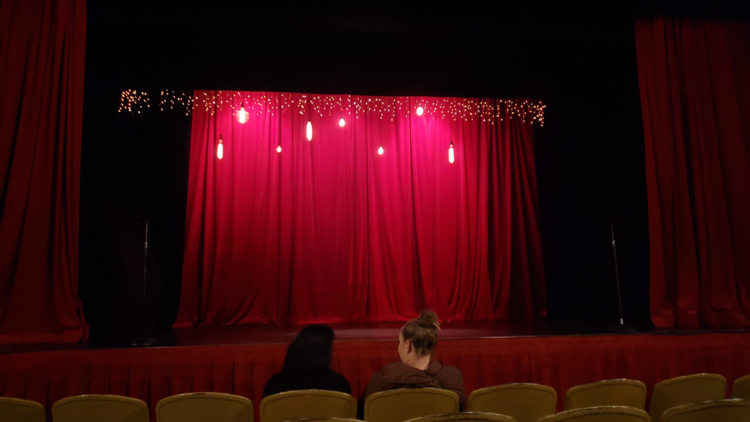 red curtains on stage for the largo at the coronet improvisational shakespeare production of henry three-thousand