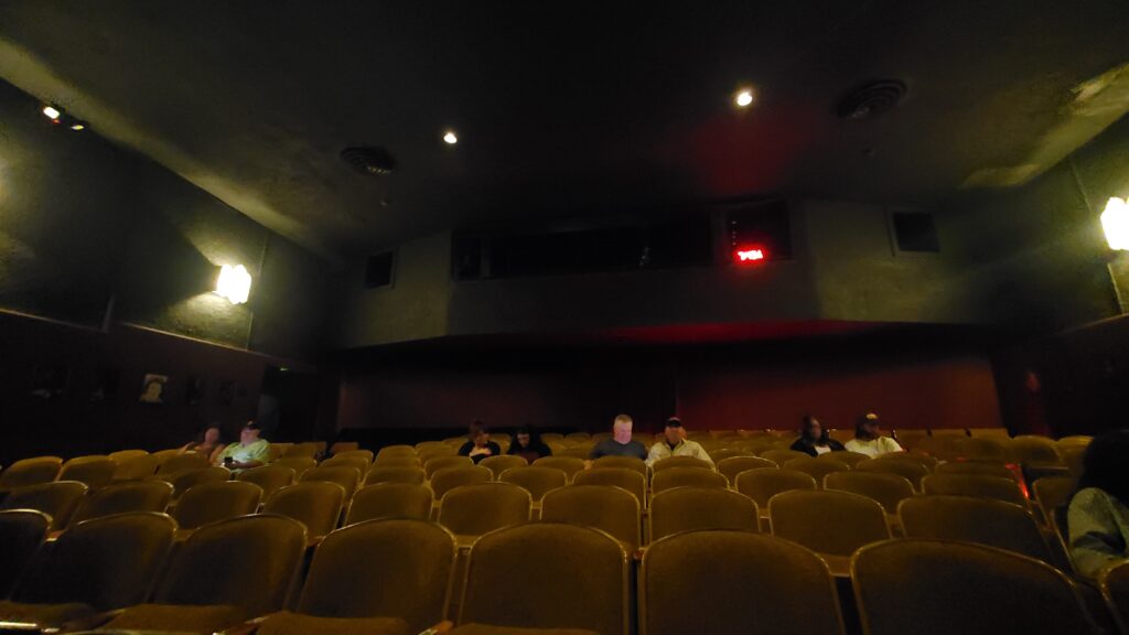 interior of the coronet theater with old seats and lighting booth